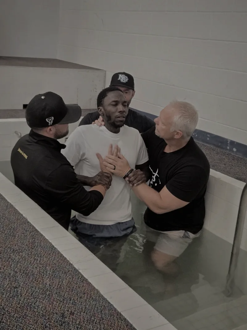 Frank Ortega baptizing an inmate in the prison chapel baptistry