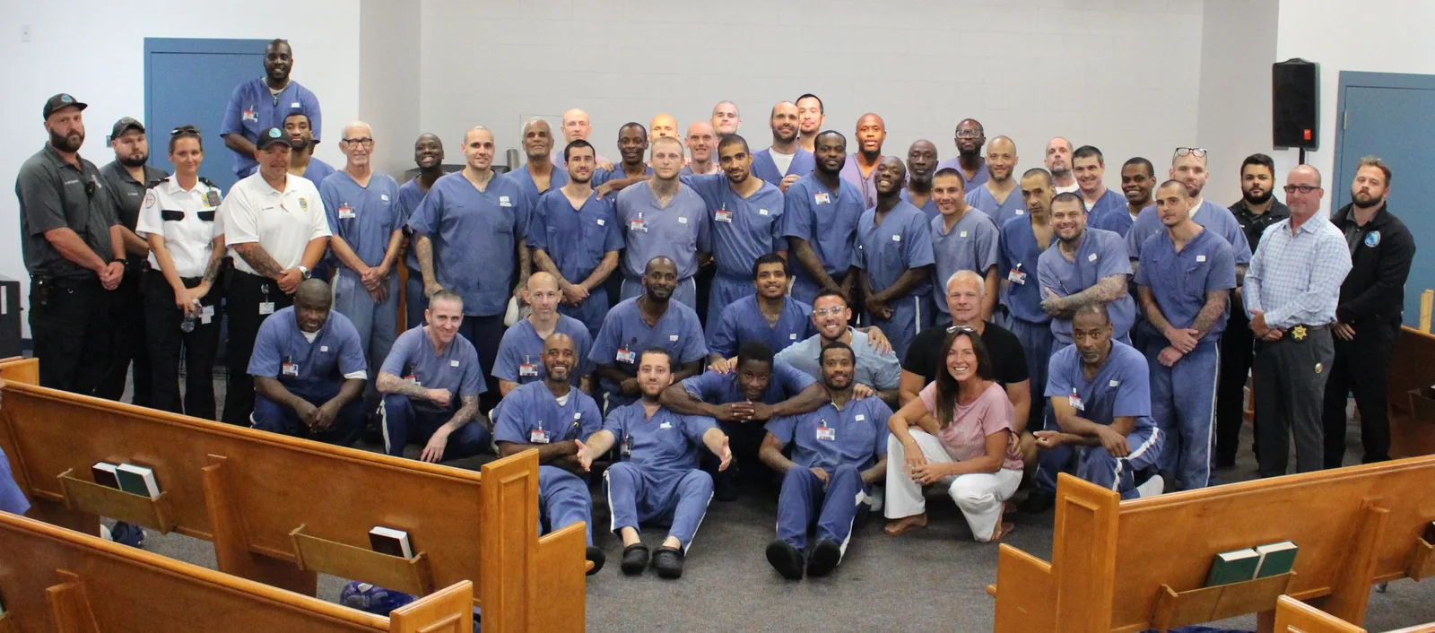 A chapel filled with incarcerated men and correctional officers gathered together after a MOG Ministries service