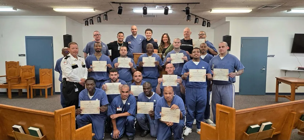 The Road to Damascus Class Two graduates together in the chapel at Suwannee Correctional Institution, with the MOG Ministries team and Lt. Harris